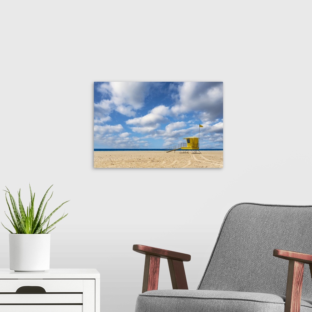 A modern room featuring Yellow lifeguard's cabin on empty sand beach, Morro Jable, Fuerteventura, Canary Islands, Spain.