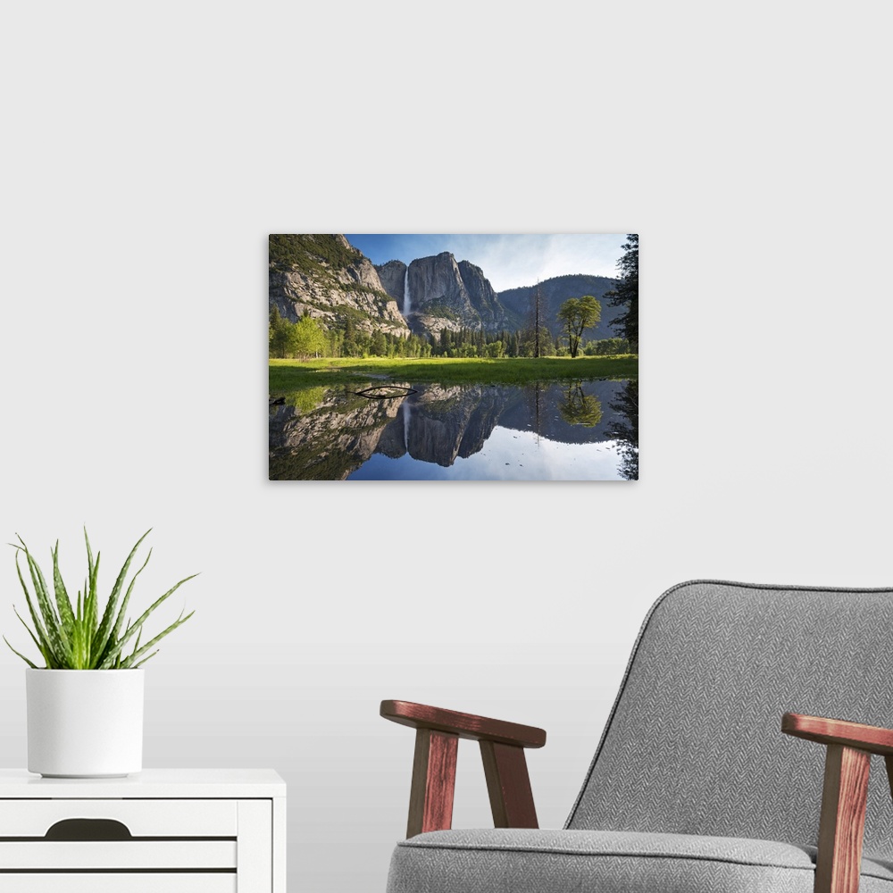 A modern room featuring Yosemite Falls viewed across a Yosemite Valley meadow, California, USA. Spring, June, 2016.
