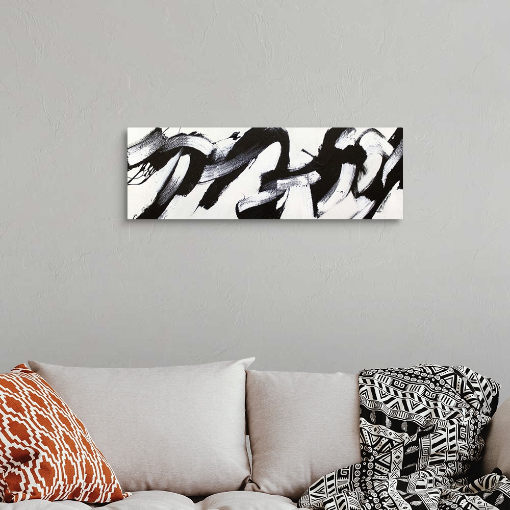 A bohemian room featuring Contemporary abstract painting of bold black strokes of paint in fluid movements against a white ...