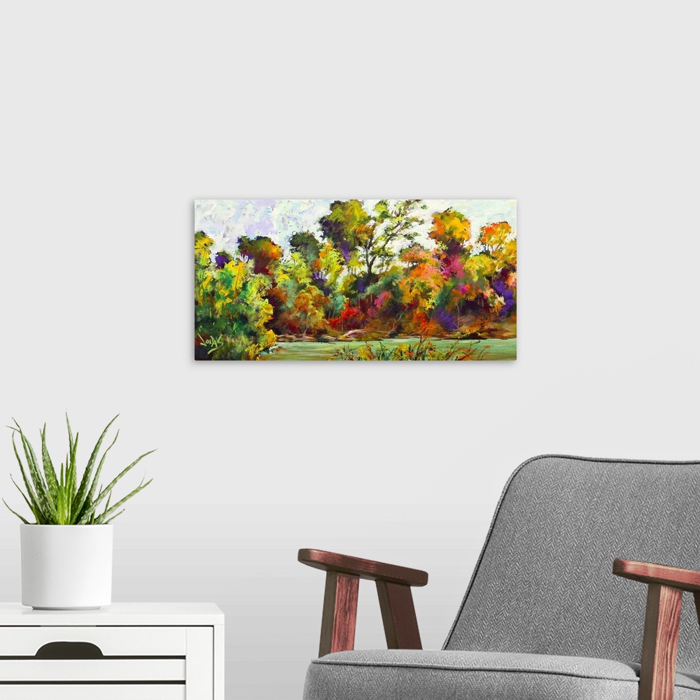 A modern room featuring Contemporary painting of a scenic view of a forest in mid color change from the seasons changing.
