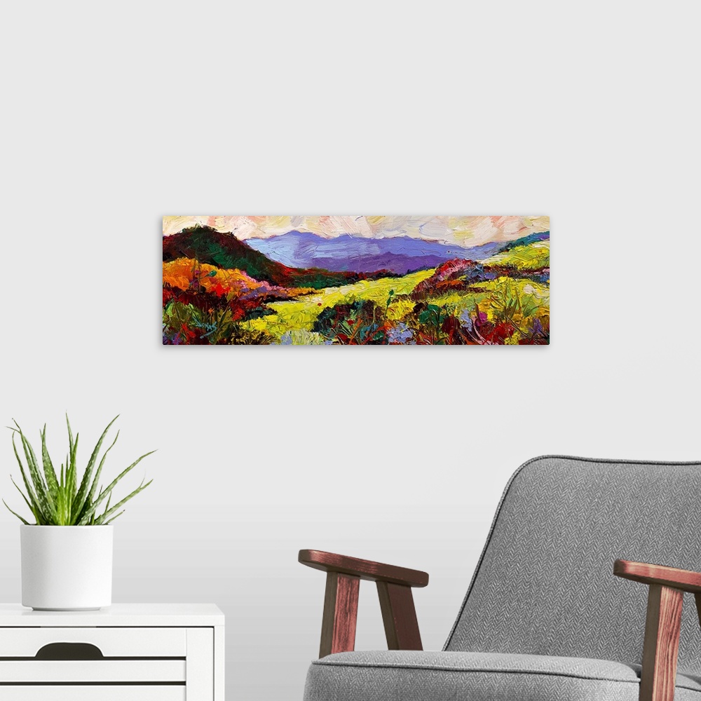 A modern room featuring A contemporary painting of a landscape in a wide range of colors.