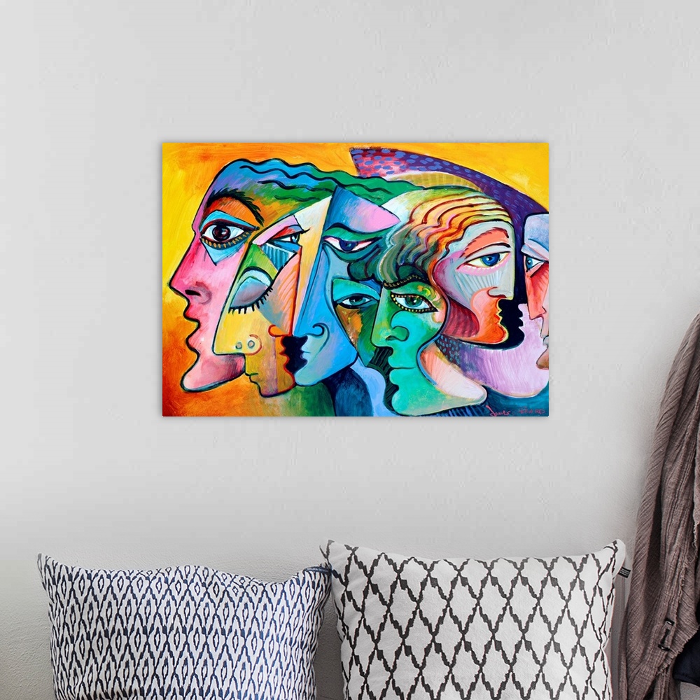 A bohemian room featuring Contemporary painting of the profiles of several figurative inspired faces.
