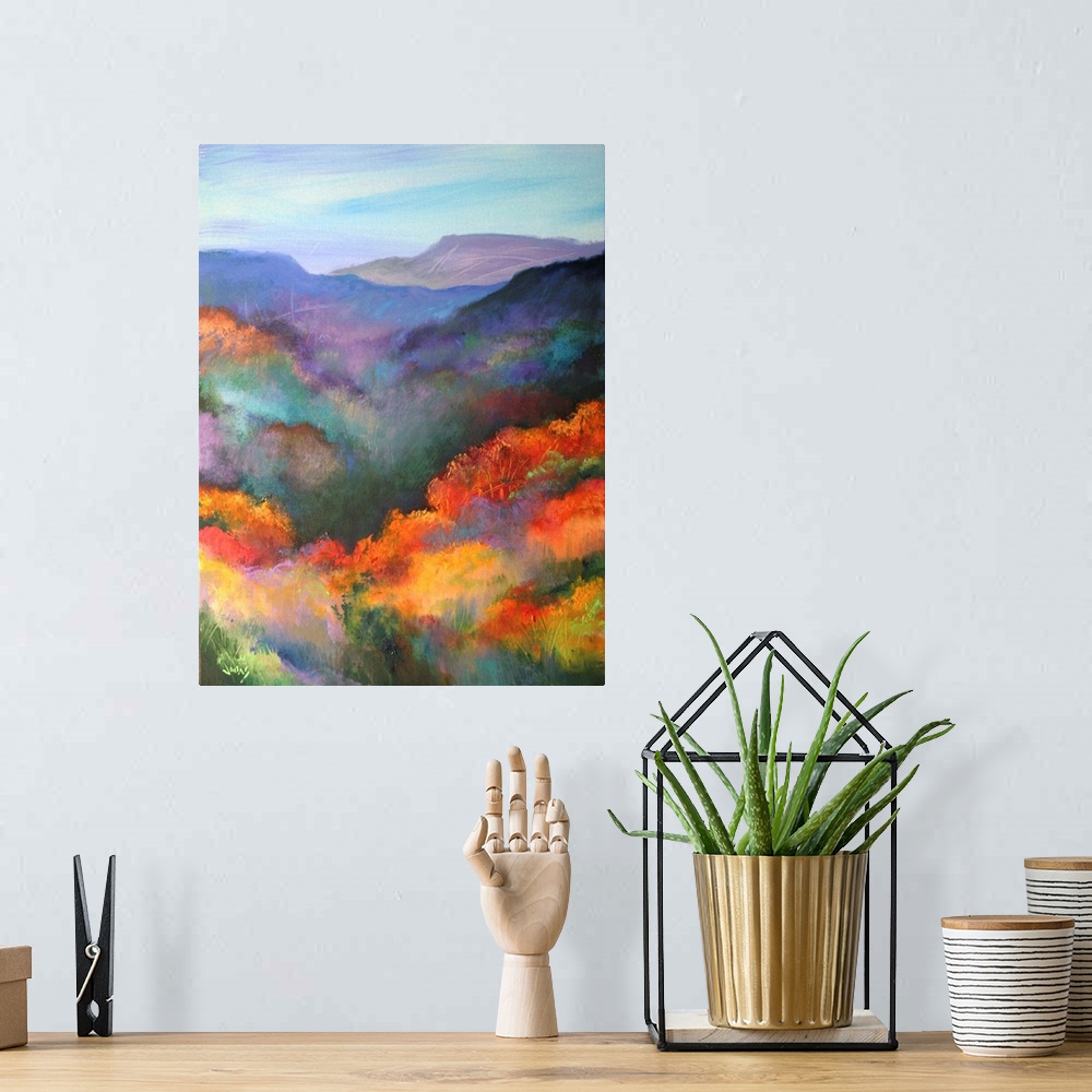 A bohemian room featuring Tall canvas painting of brightly colored trees with mountains in the distance.