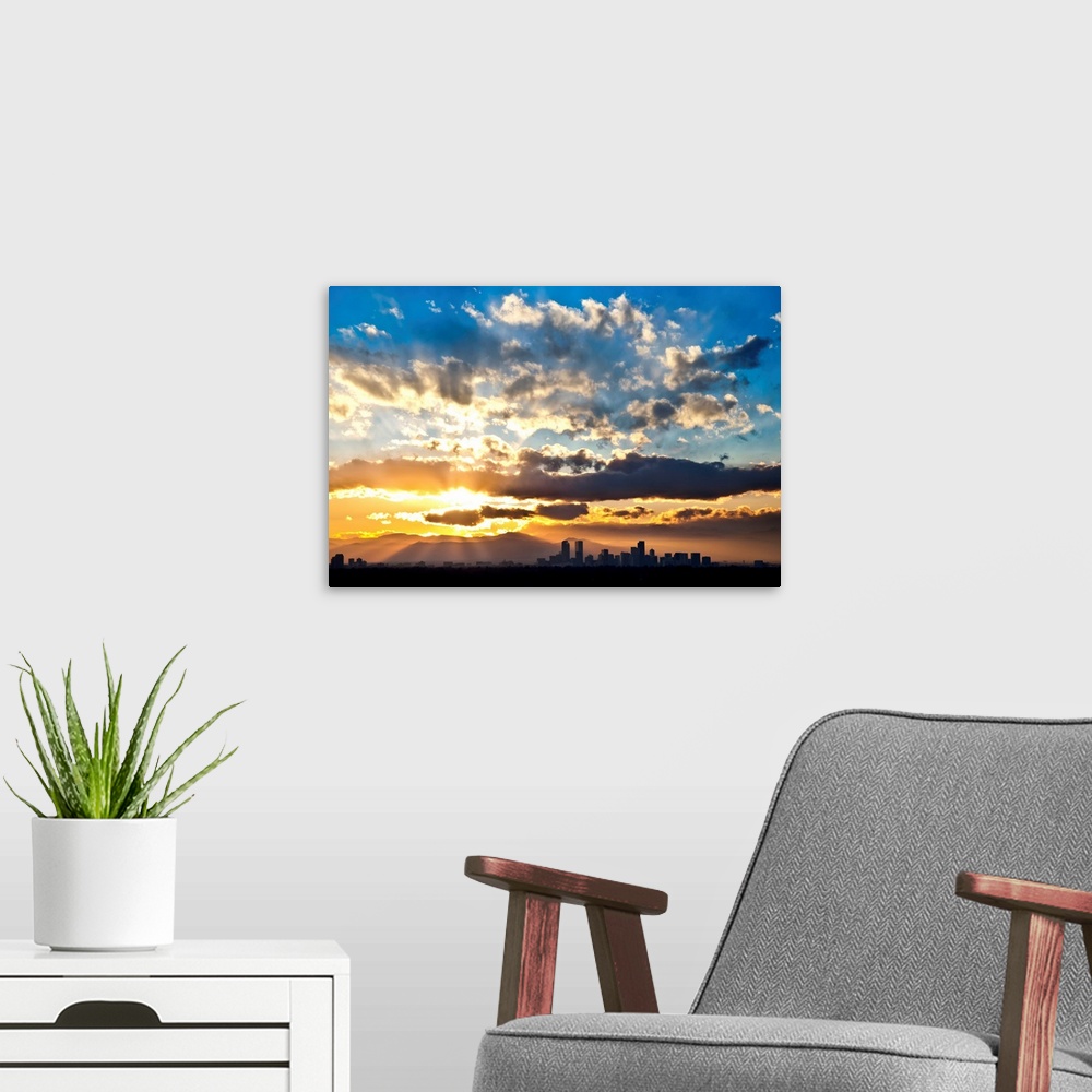 A modern room featuring Large photograph focuses on the sun's powerful rays trying to break through a sky scattered with ...