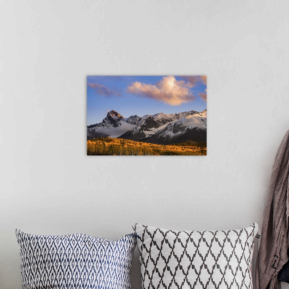 A bohemian room featuring Snow covered mountains see the waning bit of sunlight as the sun sets on the Dallas Divide with f...