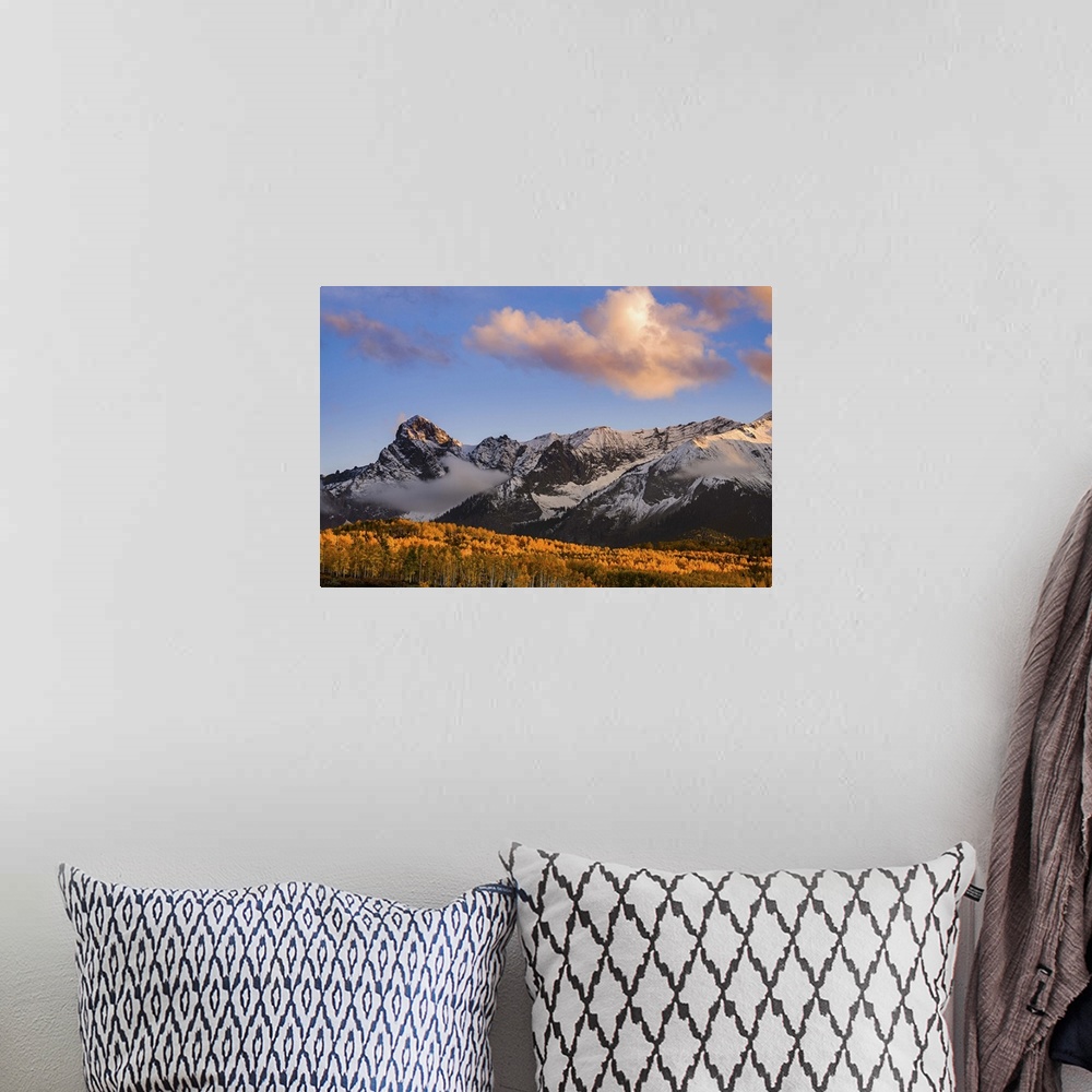 A bohemian room featuring Snow covered mountains see the waning bit of sunlight as the sun sets on the Dallas Divide with f...