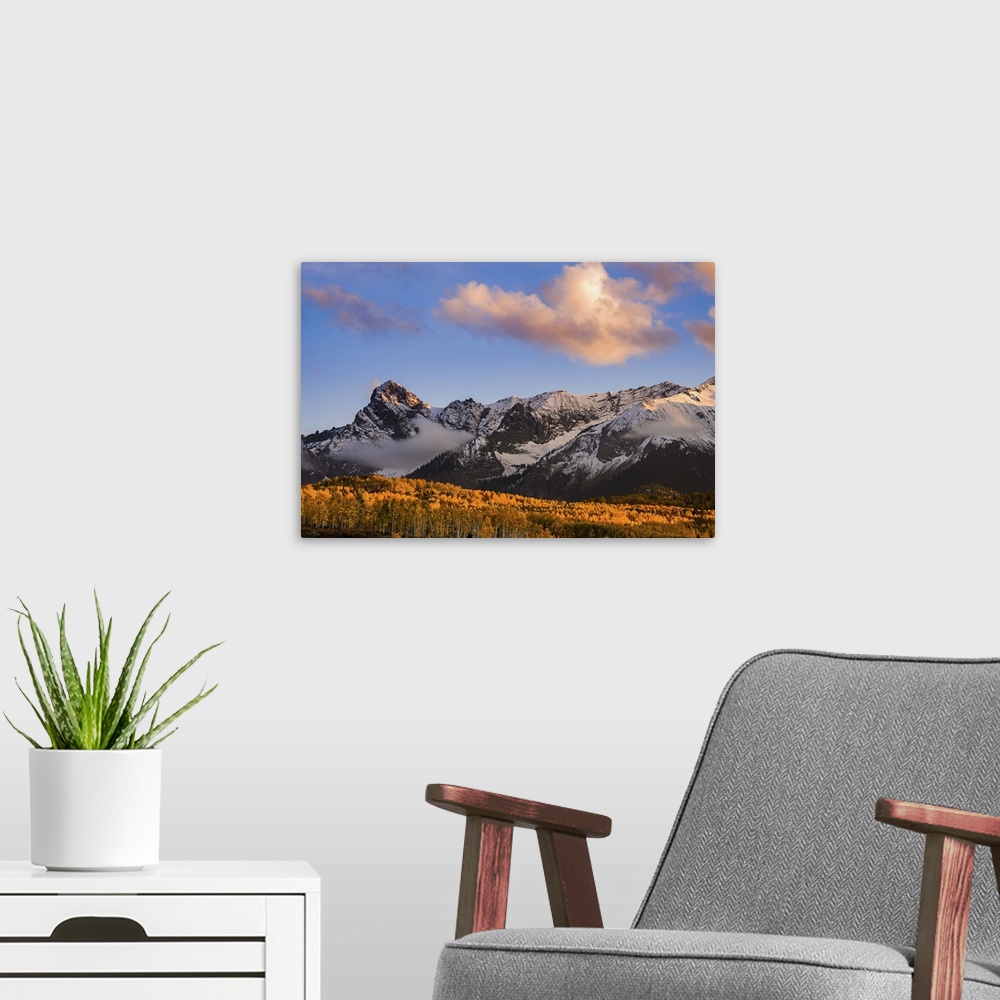 A modern room featuring Snow covered mountains see the waning bit of sunlight as the sun sets on the Dallas Divide with f...