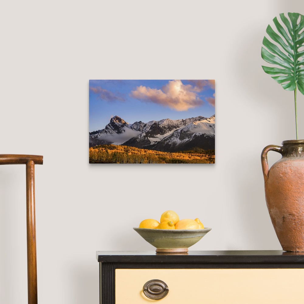 A traditional room featuring Snow covered mountains see the waning bit of sunlight as the sun sets on the Dallas Divide with f...