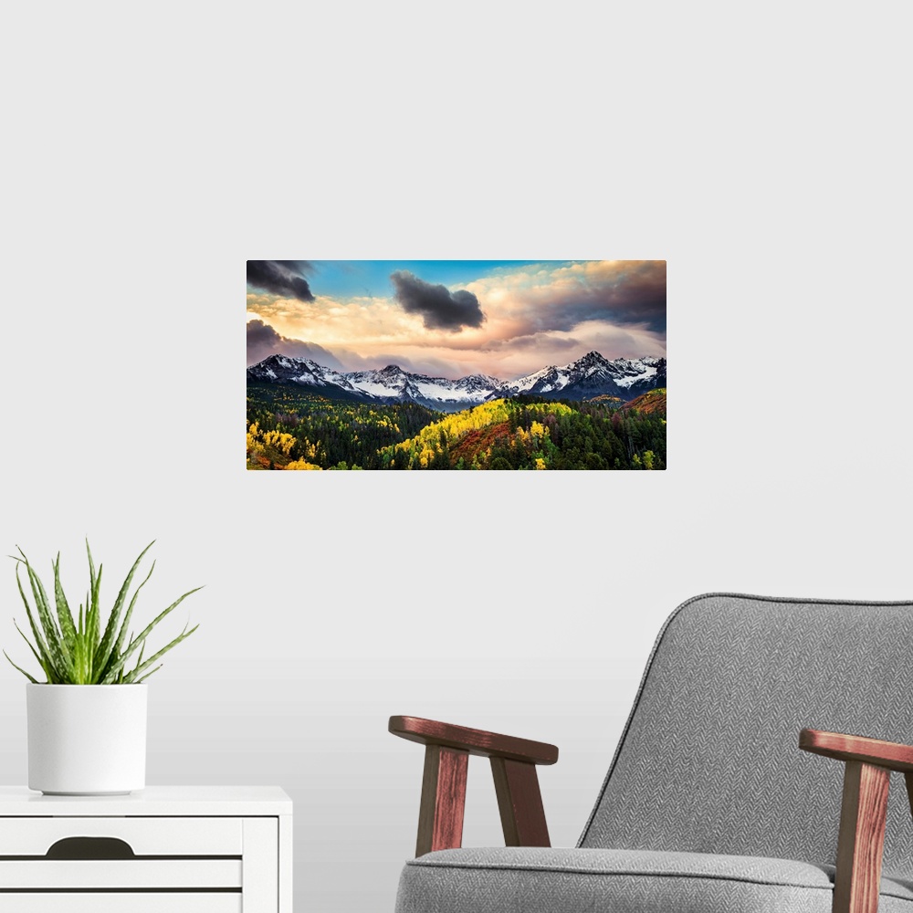 A modern room featuring Photograph of the sun about to break through the clouds over the mountains and forests of Colorad...