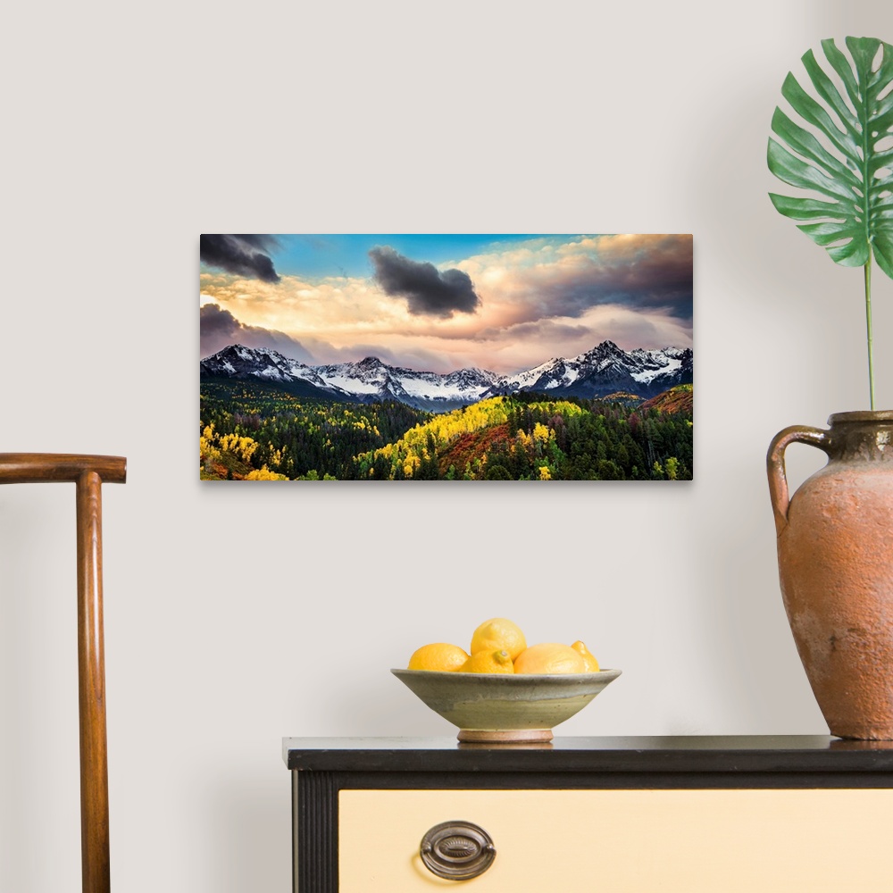 A traditional room featuring Photograph of the sun about to break through the clouds over the mountains and forests of Colorad...