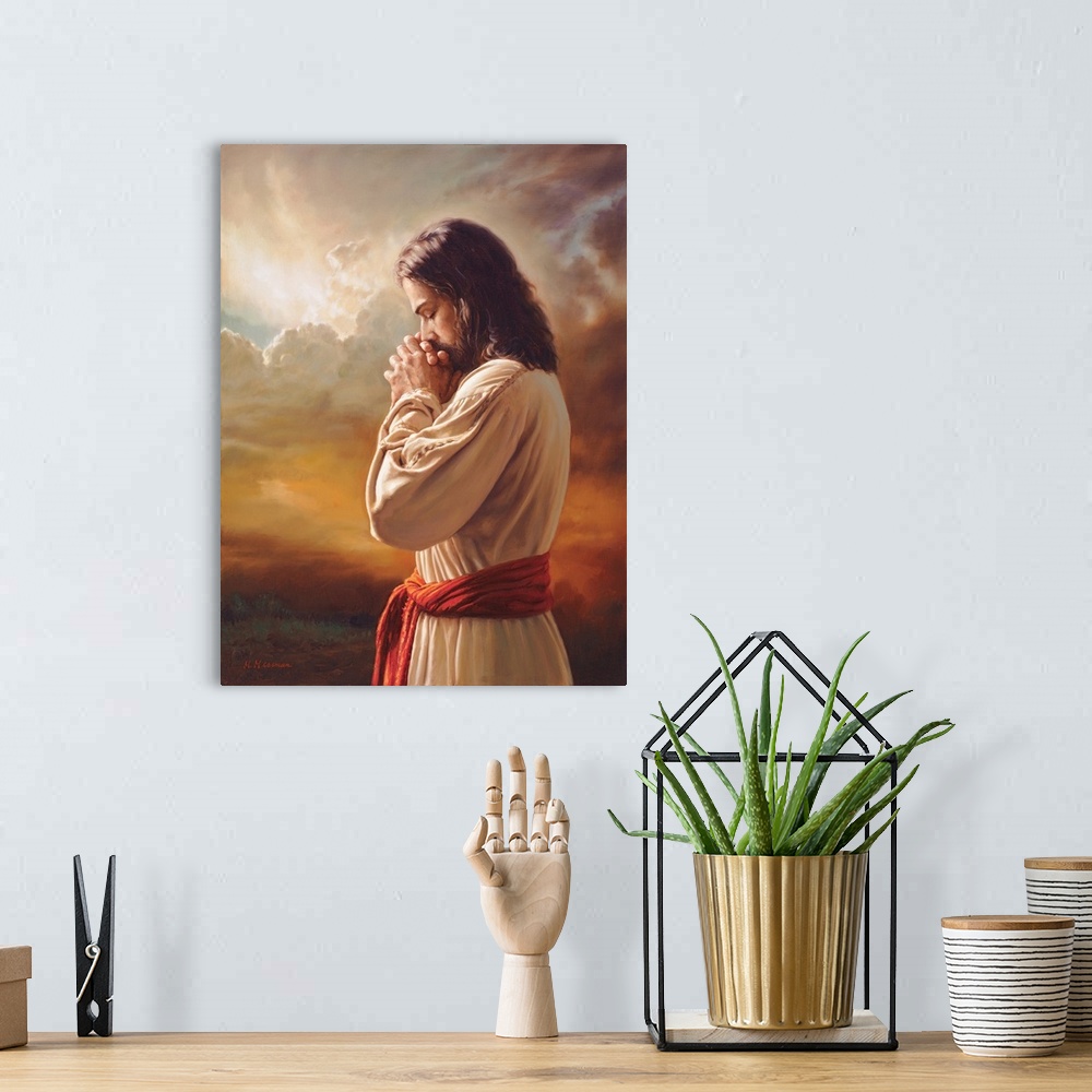 A bohemian room featuring Fine art painting of Jesus praying in front of a sunset while wearing a red belt.