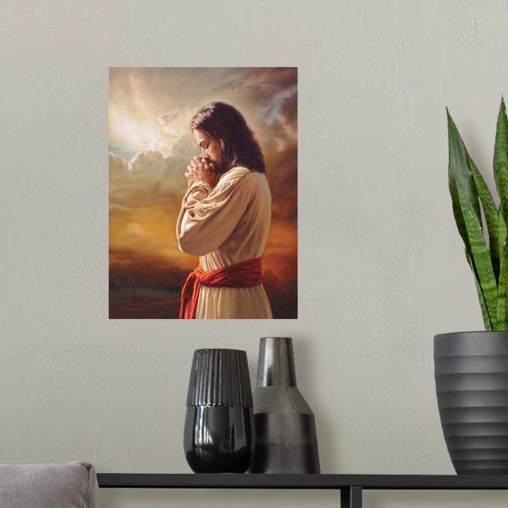 A modern room featuring Fine art painting of Jesus praying in front of a sunset while wearing a red belt.