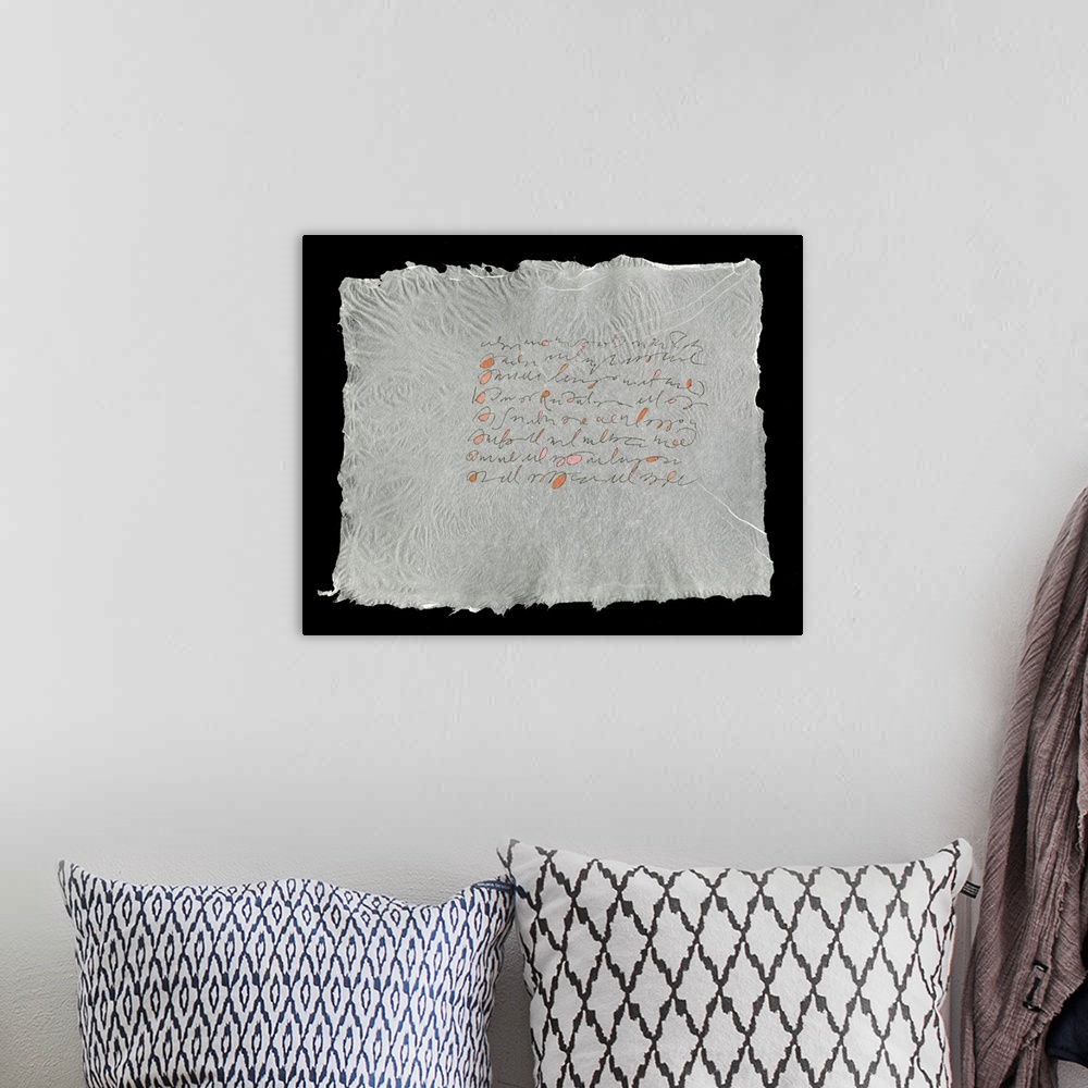 A bohemian room featuring Lines evoking handwriting set in a block on a sheet of handmade paper.