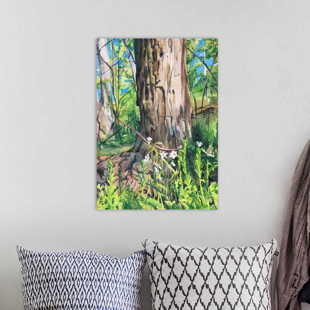 A bohemian room featuring Vertical watercolor painting of a tree thunk surrounded by a blooming forest.
