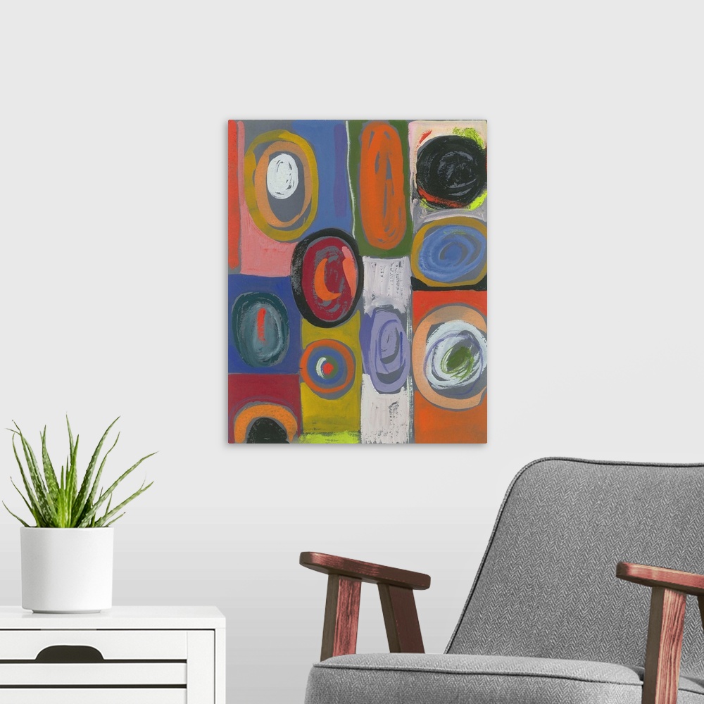 A modern room featuring Painting of circular shapes in various hues and sizes over blocks of color.