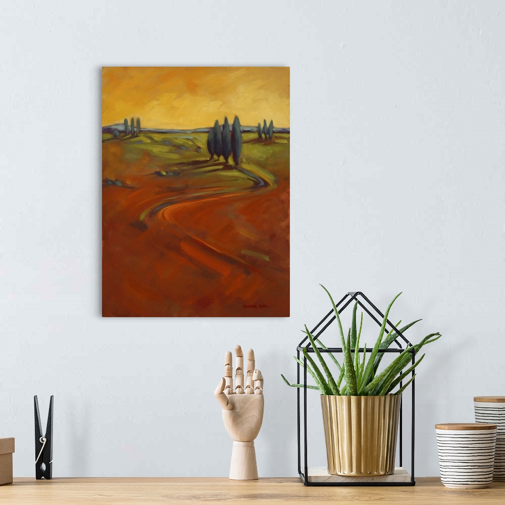 A bohemian room featuring A contemporary painting of cypress trees on a hill in warm colors of orange and yellow.