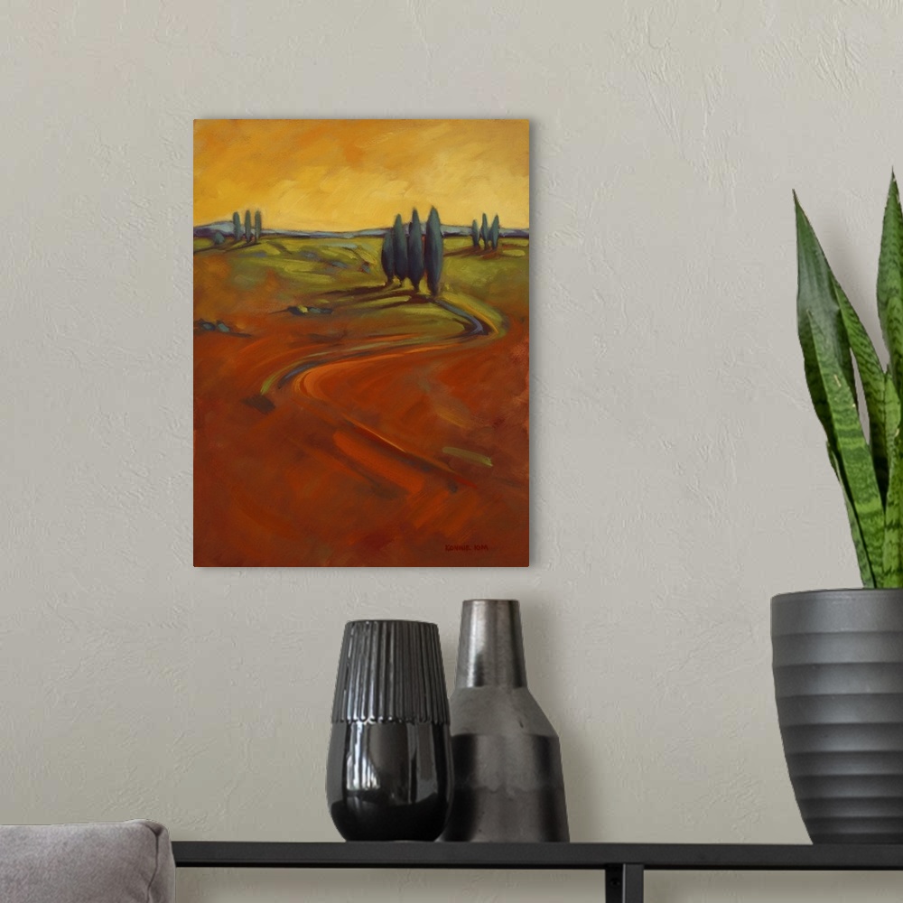 A modern room featuring A contemporary painting of cypress trees on a hill in warm colors of orange and yellow.
