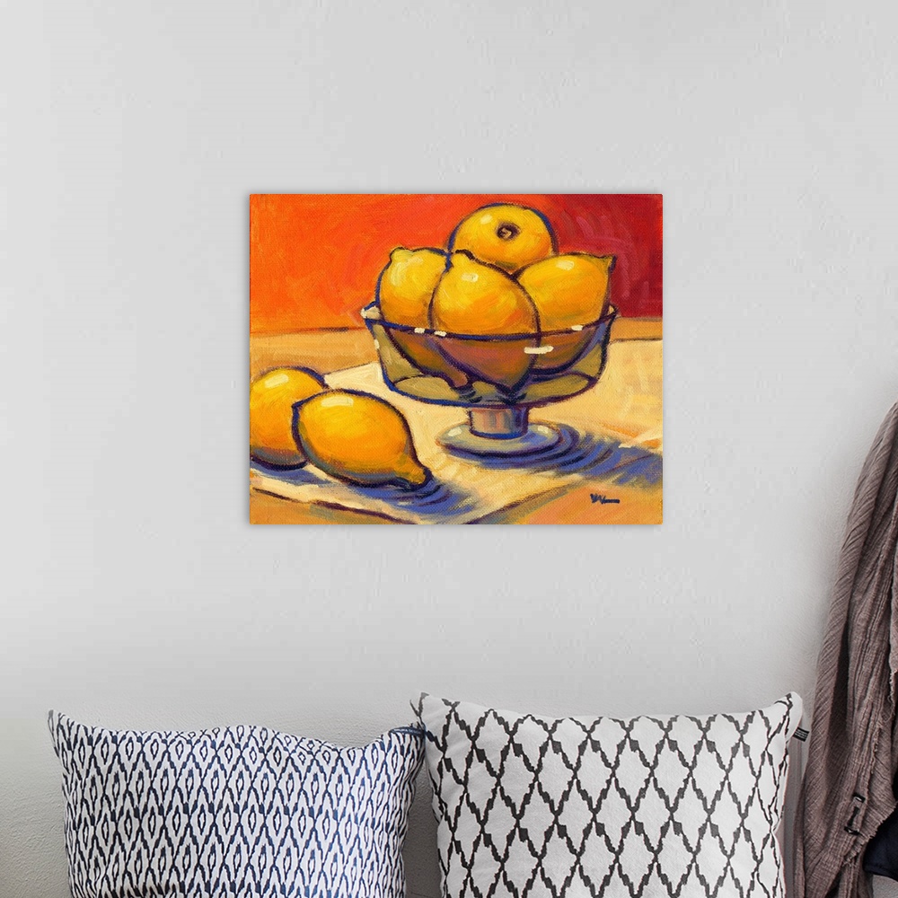 A bohemian room featuring A contemporary abstract painting of a bowl of lemons against a orange background.