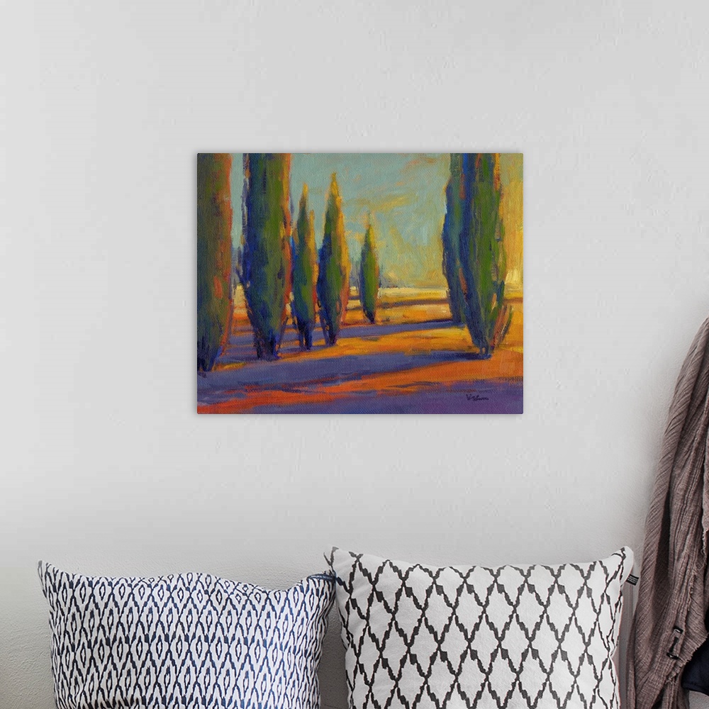 A bohemian room featuring A contemporary painting of a divide between a row of cypress trees in golden colors.