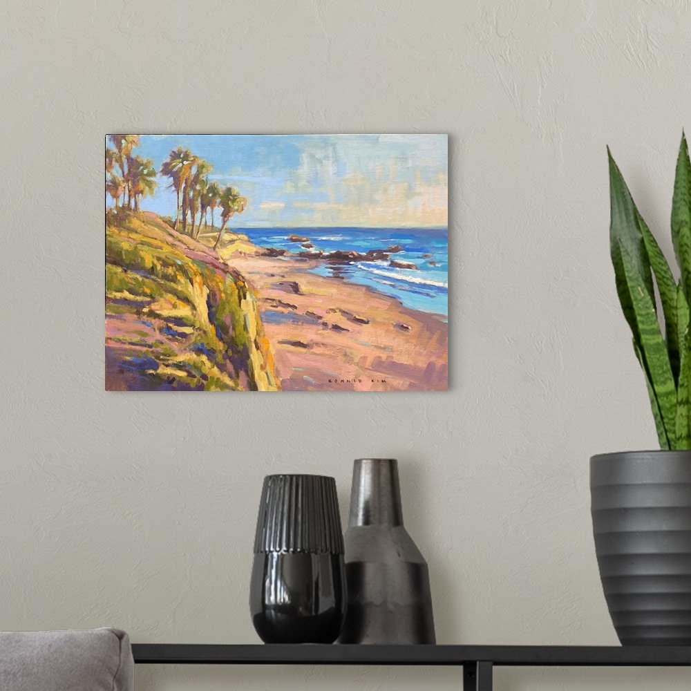 A modern room featuring A contemporary impressionist painting of palm trees and a rocky coastline as the sun sets