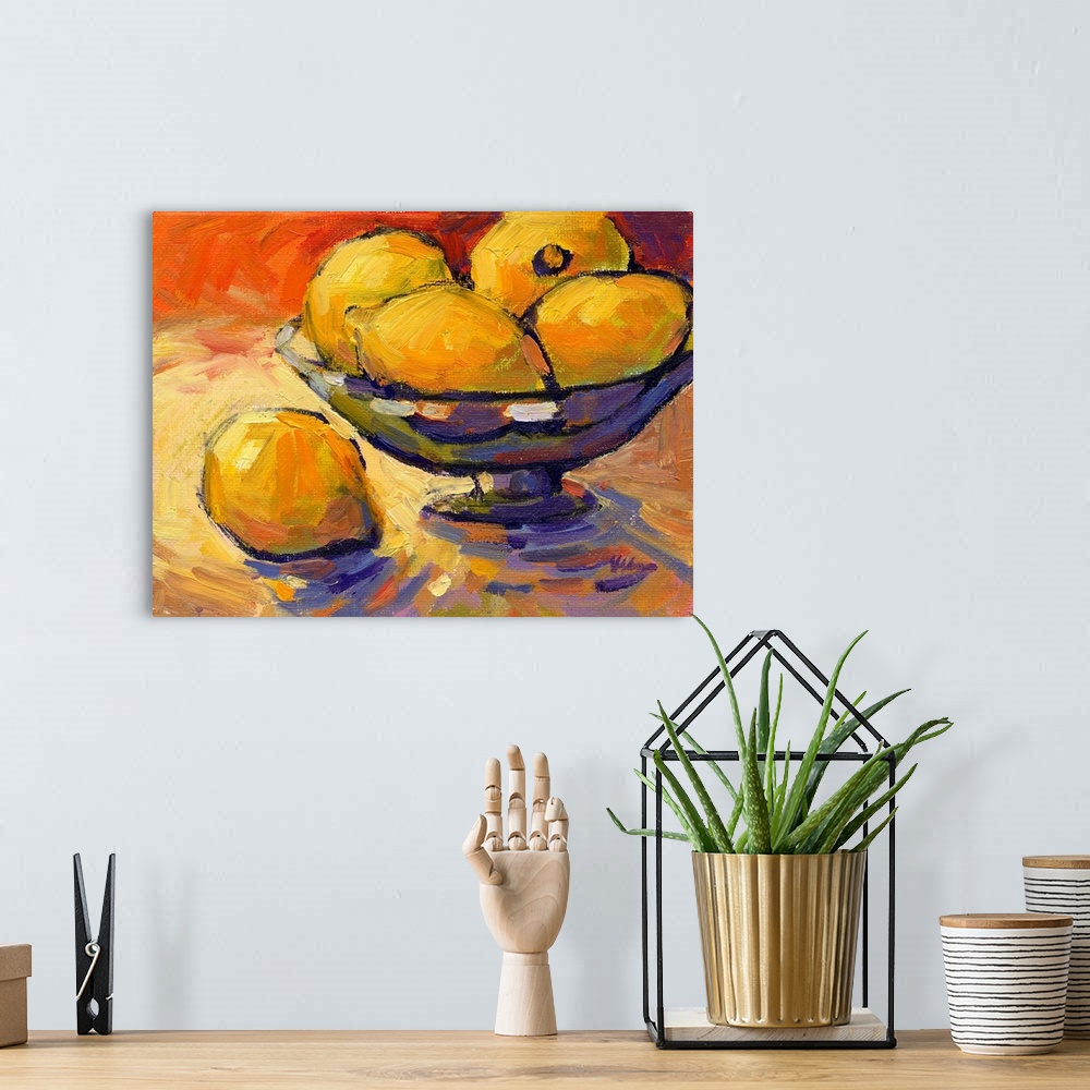 A bohemian room featuring A contemporary abstract painting of a bowl of lemons against a red background.
