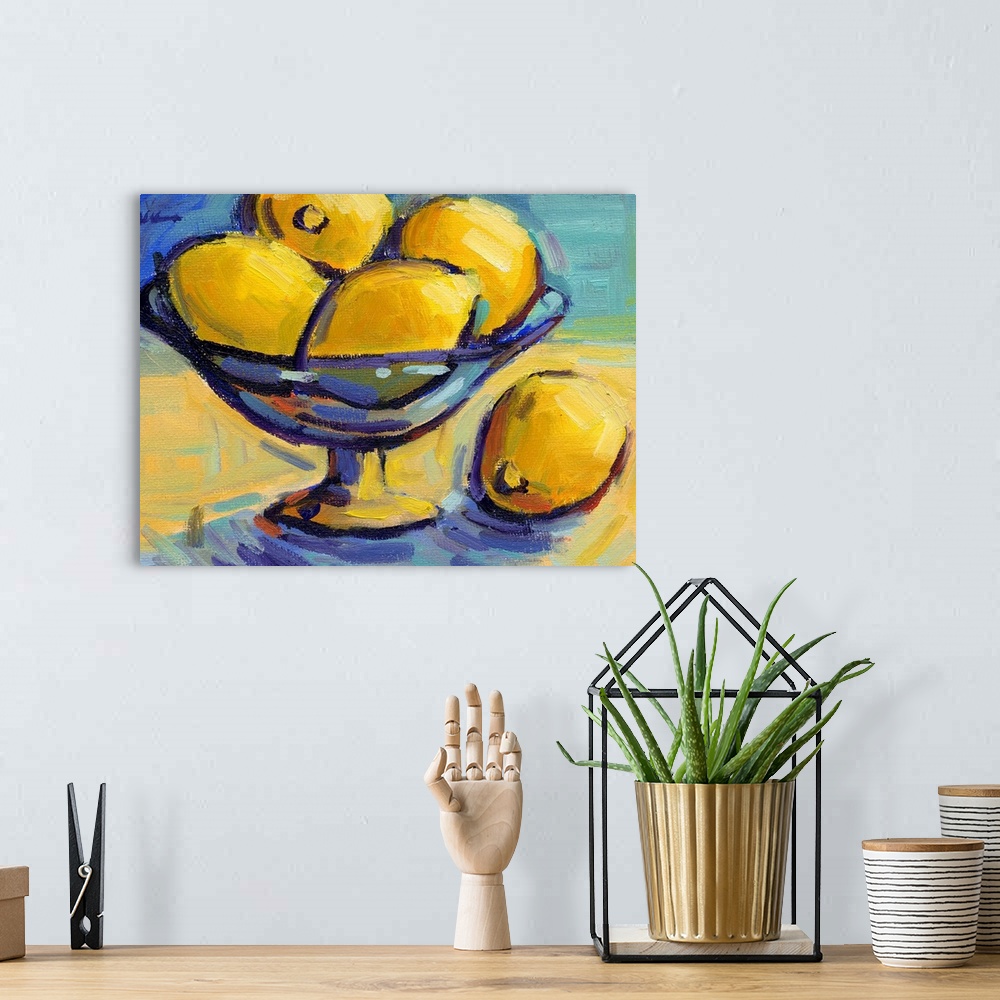 A bohemian room featuring A contemporary abstract painting of a bowl of lemons against a blue background.