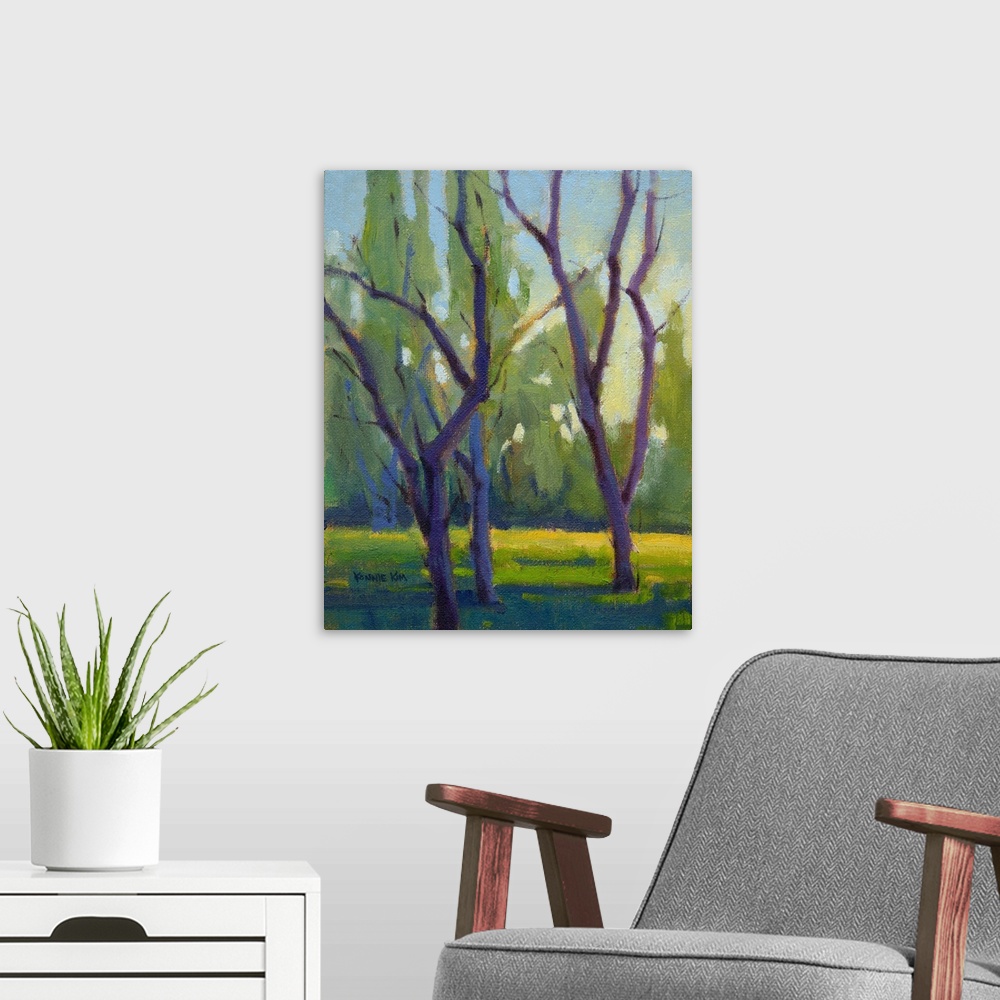 A modern room featuring Vertical painting of bare trees.