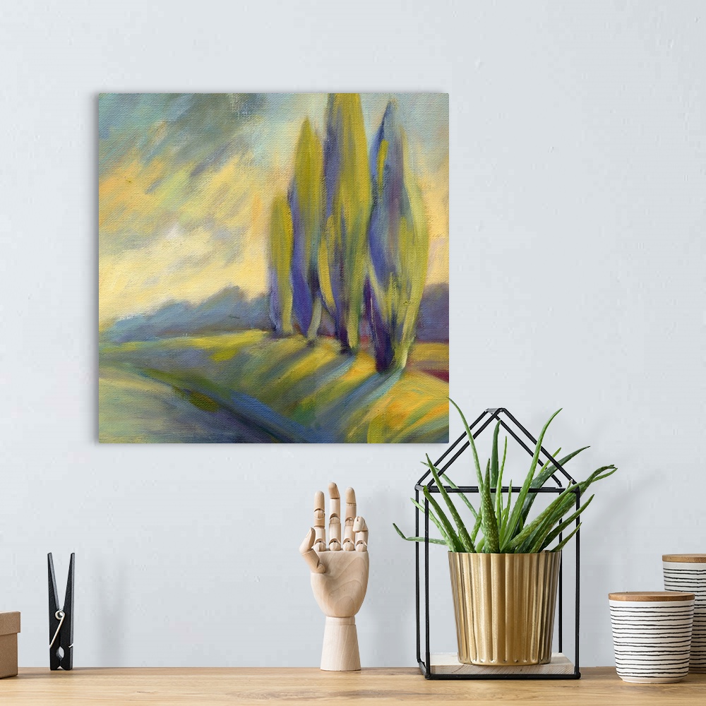 A bohemian room featuring A square painting of a row of cypress tress next to a road.