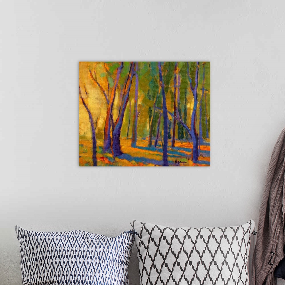 A bohemian room featuring Contemporary painting of trees in a forest with strong golden light shining through at golden hour.