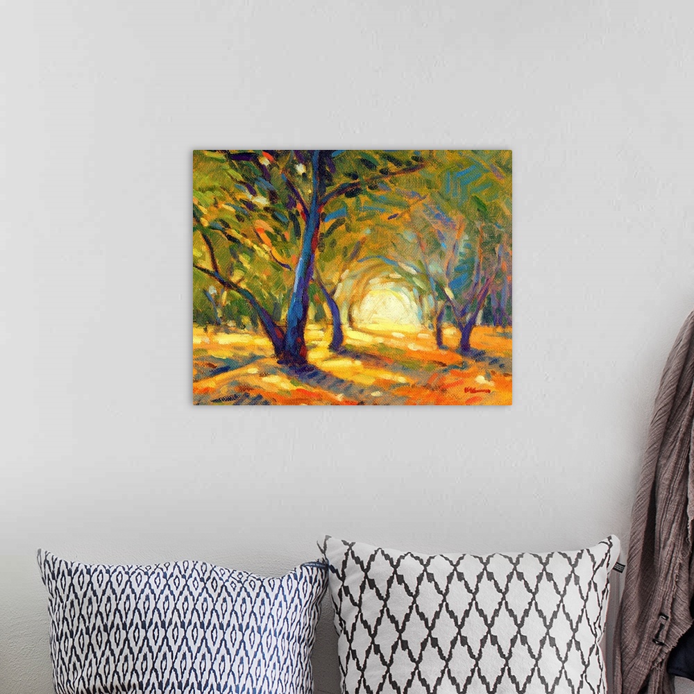 A bohemian room featuring A horizontal contemporary painting of colorful autumn forest.