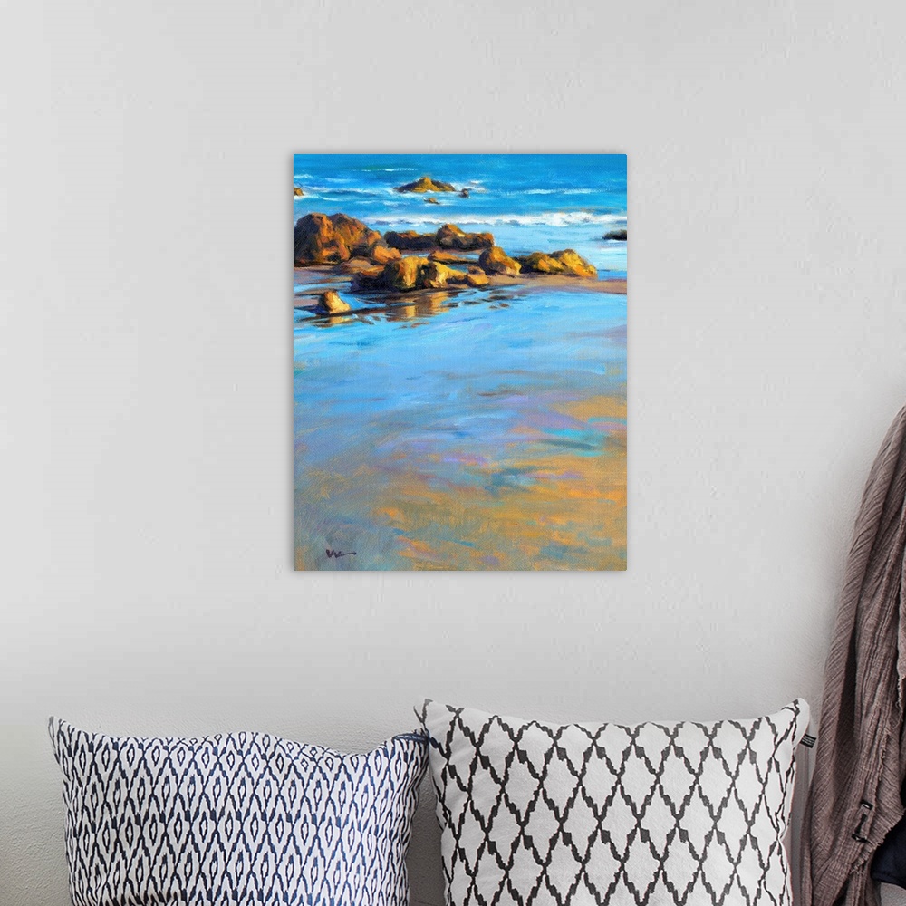 A bohemian room featuring Contemporary painting of a rocky beach with vivid blue water.