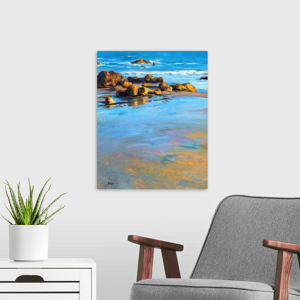 A modern room featuring Contemporary painting of a rocky beach with vivid blue water.