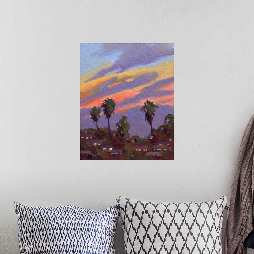 A bohemian room featuring A vertical painting of palm trees with a vibrant sunset.