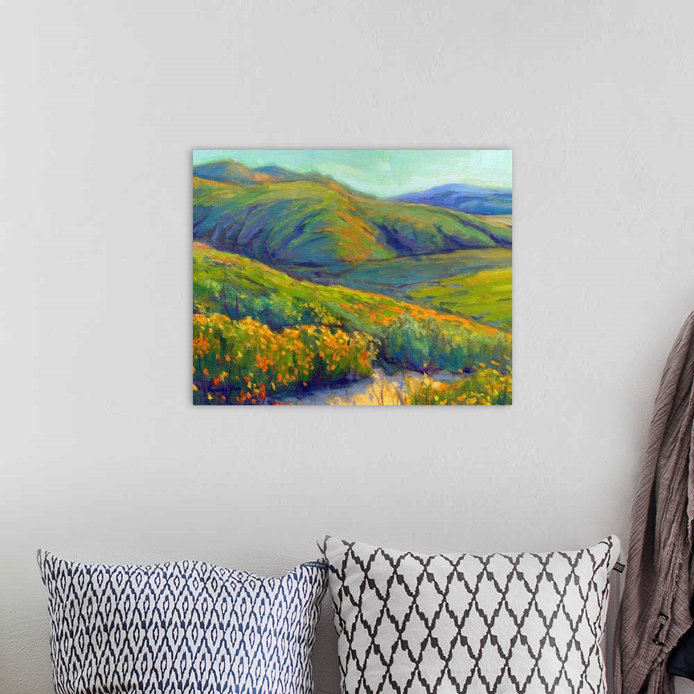 A bohemian room featuring A contemporary painting of a row of wild flowers and rolling hills in vibrant colors.