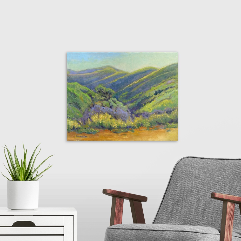 A modern room featuring A contemporary painting of a row of trees and rolling hills in vibrant colors.