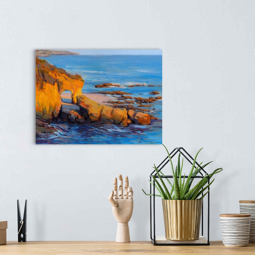 A bohemian room featuring Horizontal contemporary painting of a rocky cliff and a beach with vivid blue water.