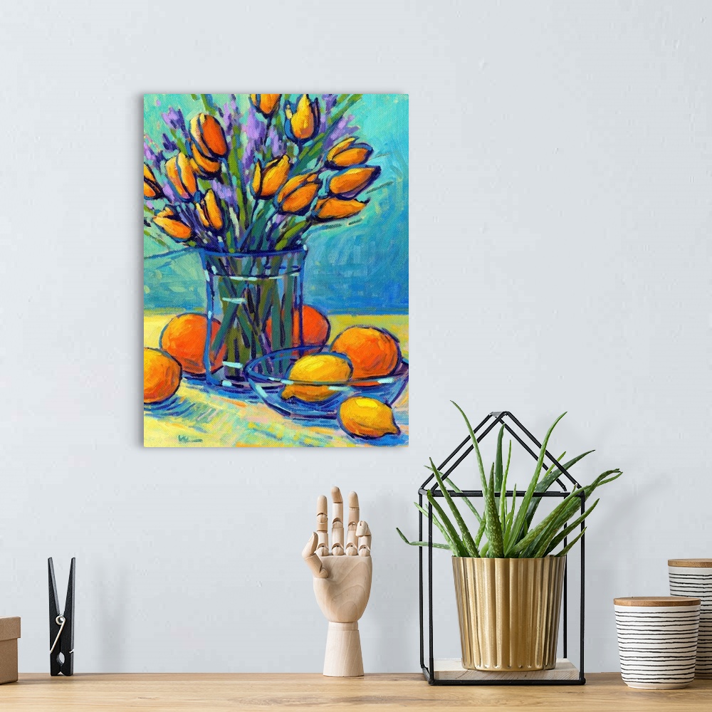 A bohemian room featuring A vertical contemporary painting of a glass vase of tulips with oranges and lemons.