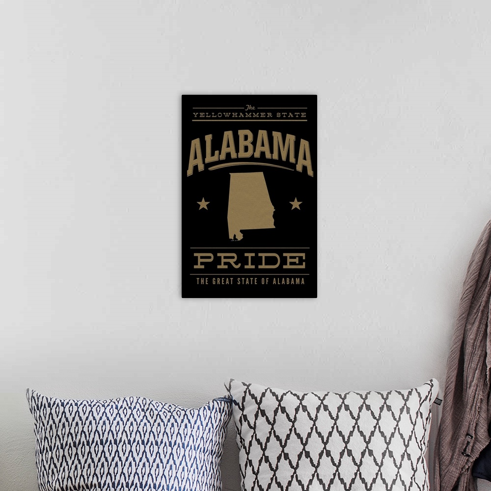 A bohemian room featuring The Alabama state outline on black with gold text.