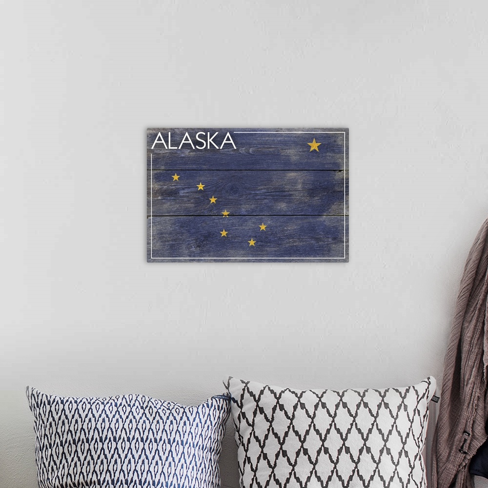 A bohemian room featuring The flag of Alaska with a weathered wooden board effect.