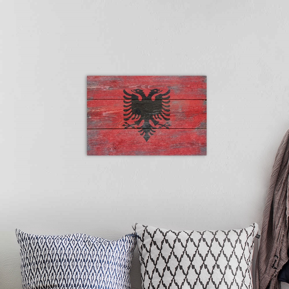 A bohemian room featuring The flag of Albania with a weathered wooden board effect.