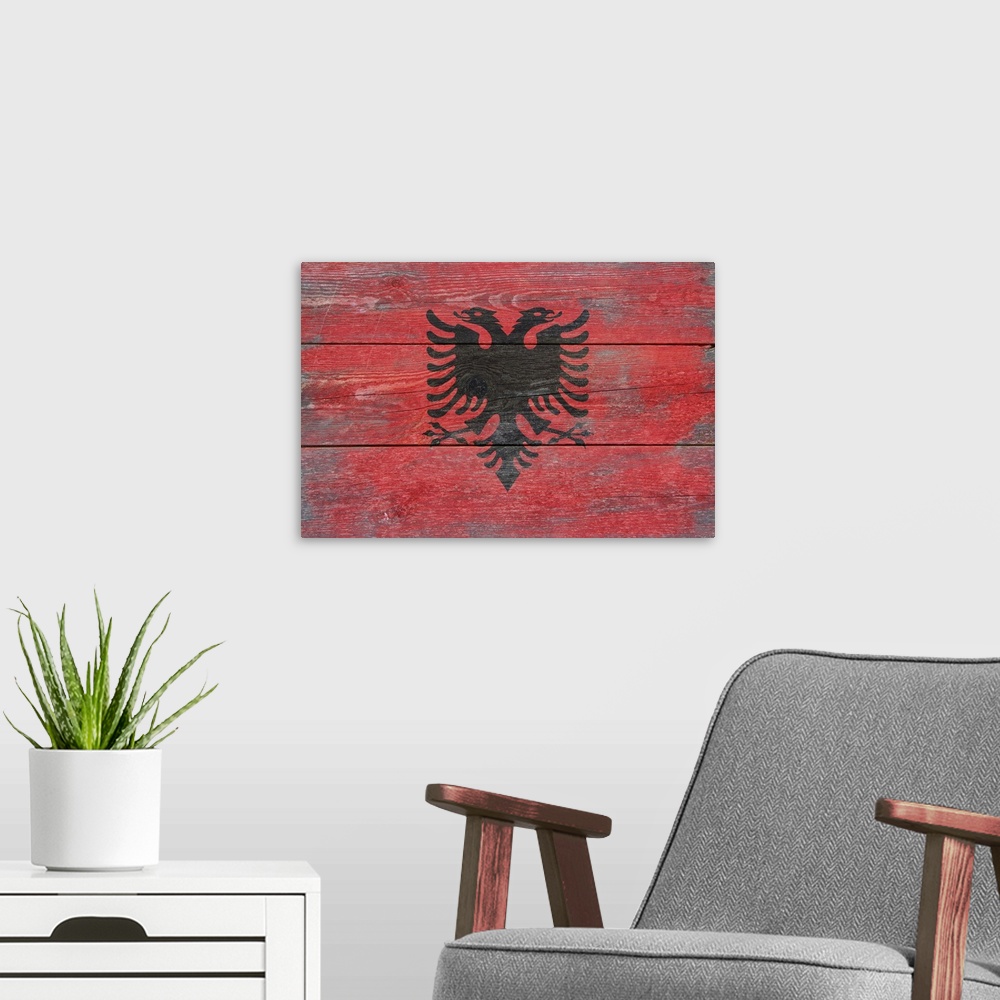 A modern room featuring The flag of Albania with a weathered wooden board effect.