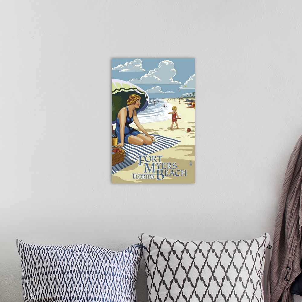 A bohemian room featuring Retro stylized art poster of a woman sitting on a blanket under an umbrella on a beach.