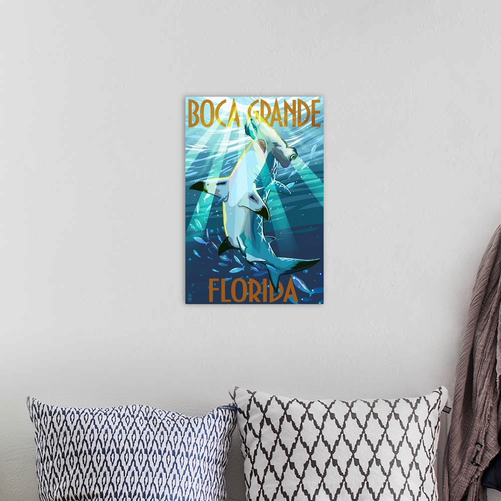A bohemian room featuring Stylized art poster of a hammerhead shark in the water, with rays of sunlight piercing the water.