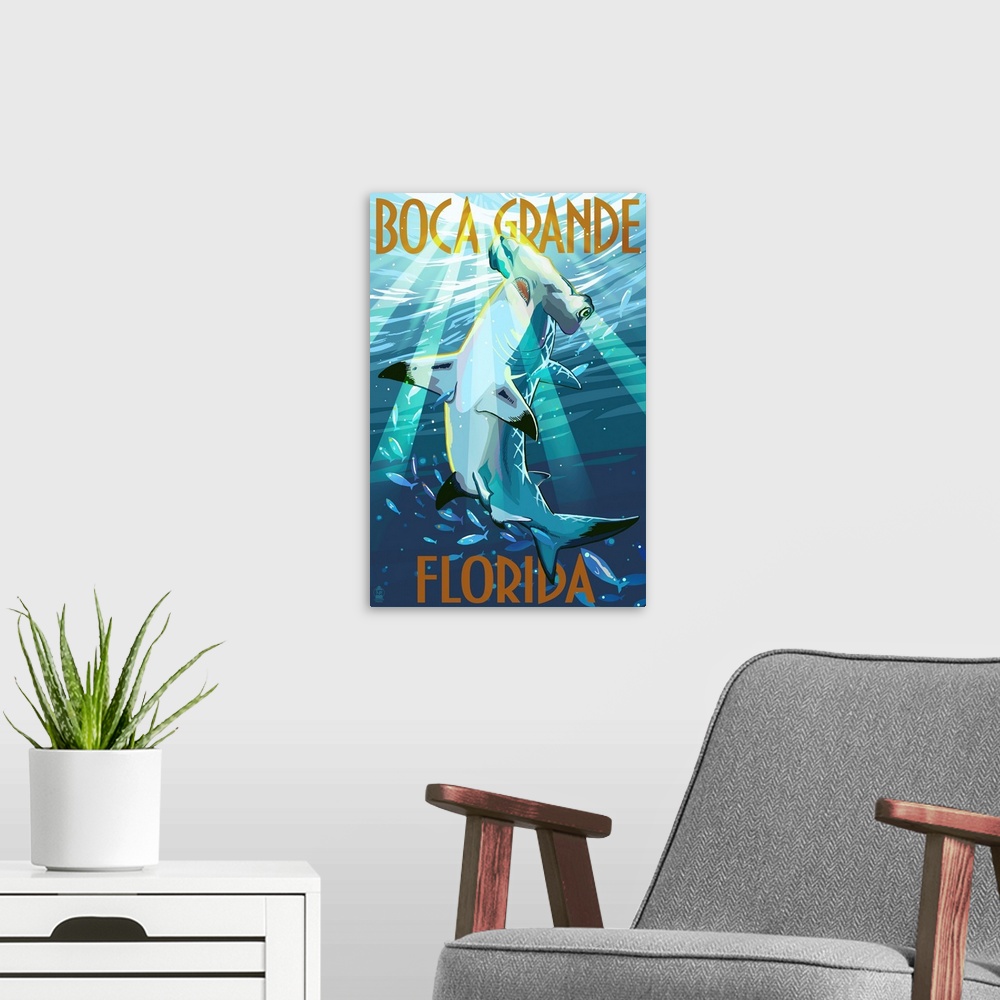 A modern room featuring Stylized art poster of a hammerhead shark in the water, with rays of sunlight piercing the water.