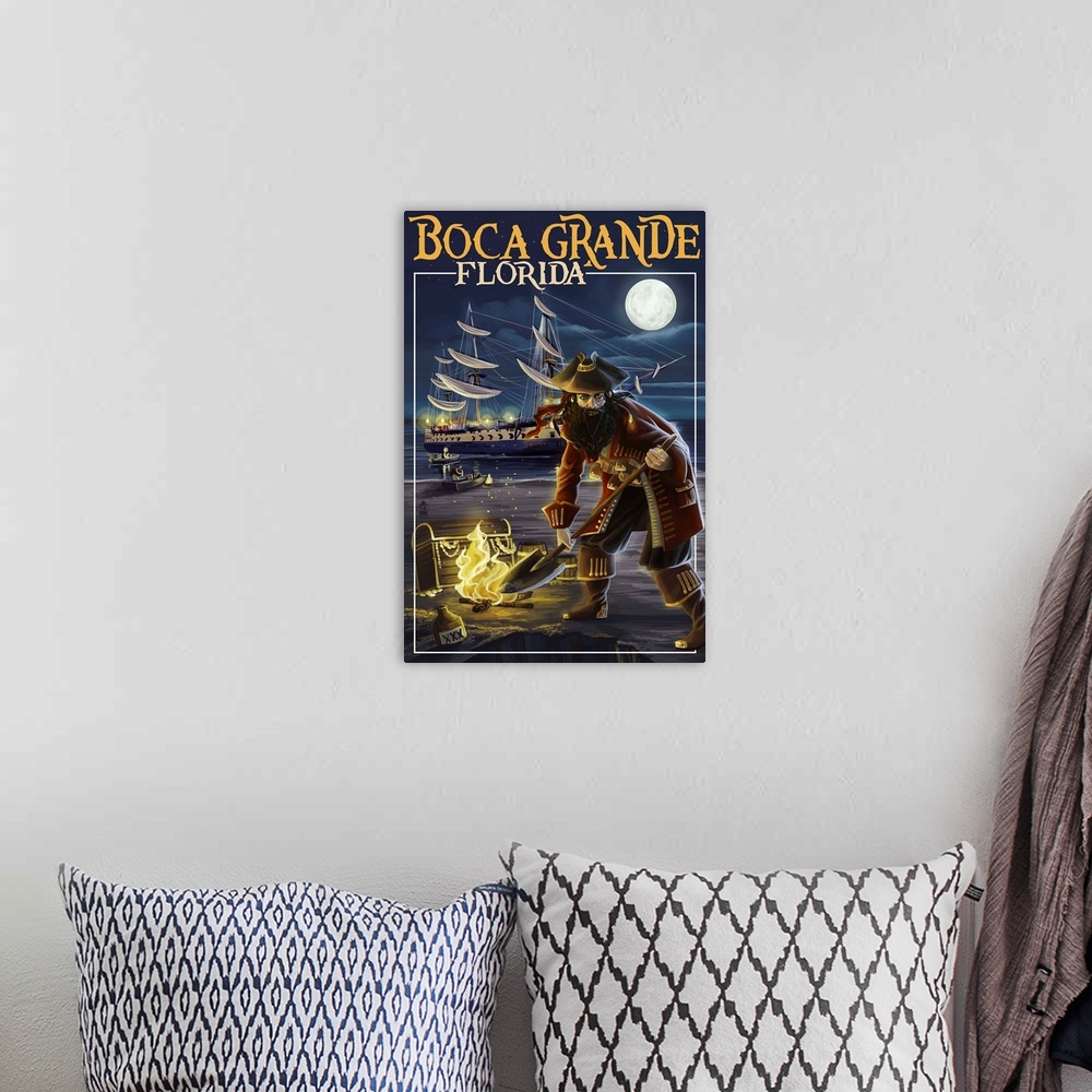 A bohemian room featuring Stylized art poster showing a pirate digging for gold and a tall ship in the background.