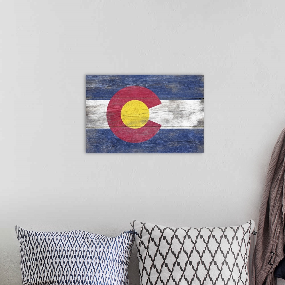 A bohemian room featuring The flag of Colorado with a weathered wooden board effect.