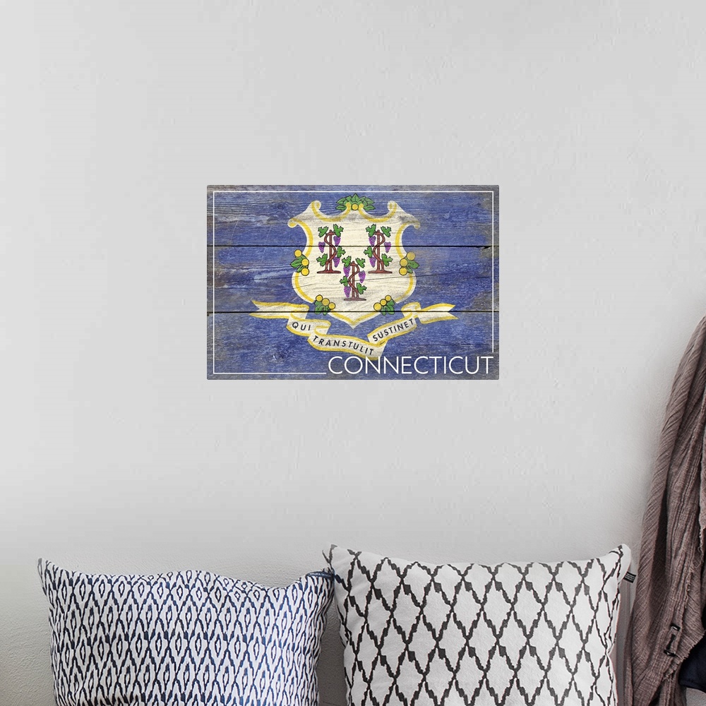 A bohemian room featuring The flag of Connecticut with a weathered wooden board effect.