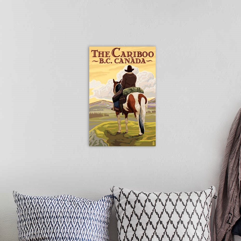 A bohemian room featuring Retro stylized art poster of a cowboy on horseback looking out over a rugged landscape.