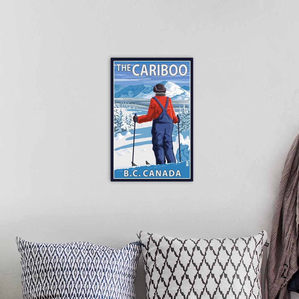 A bohemian room featuring Retro stylized art poster of a skier stopped and gazing out over a snowy mountainous landscape.