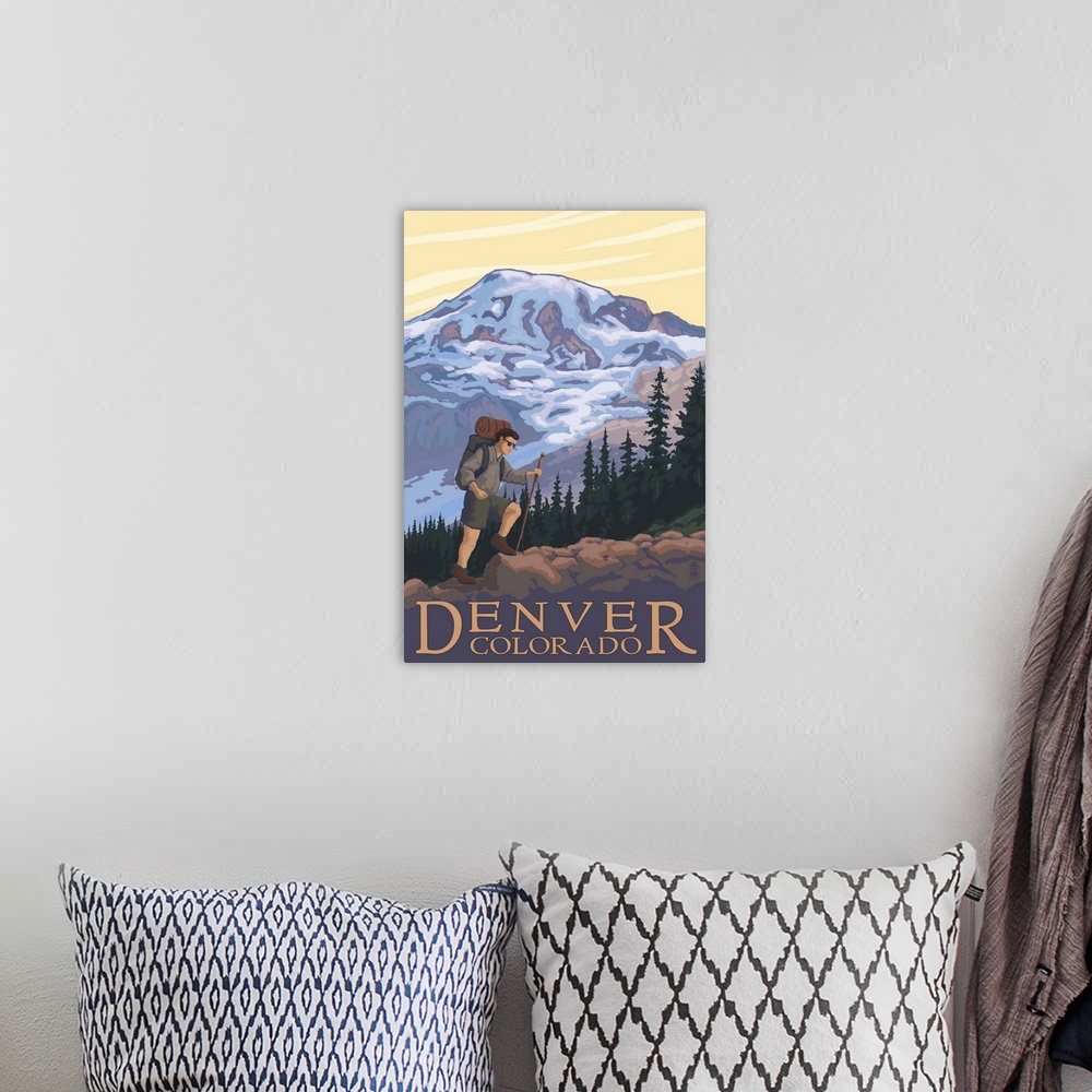 A bohemian room featuring Retro stylized art poster of a hiker walking a trail, with a mountain in the background.